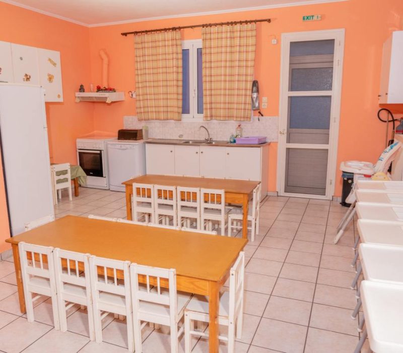 Καθαρή και οργανωμένη τραπεζαρία όπου τα παιδιά απολαμβάνουν τα σπιτικά τους γεύματα.